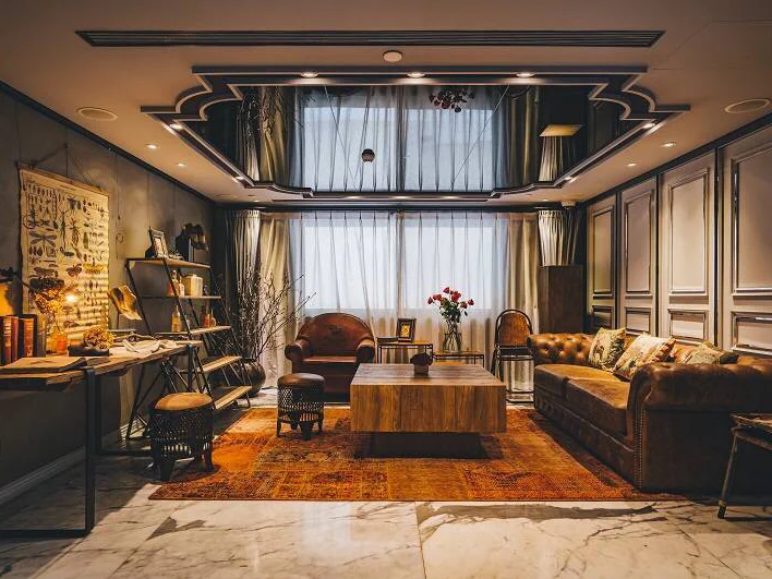 Dark theatrical lobby with red curtains and vintage props