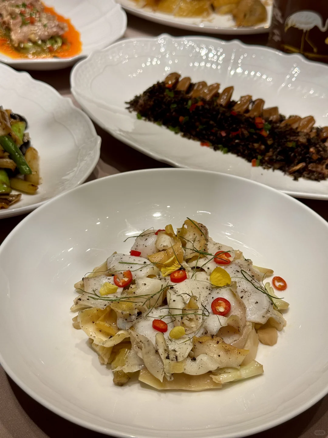 steaming dim sum baskets and roasted meats on traditional plates