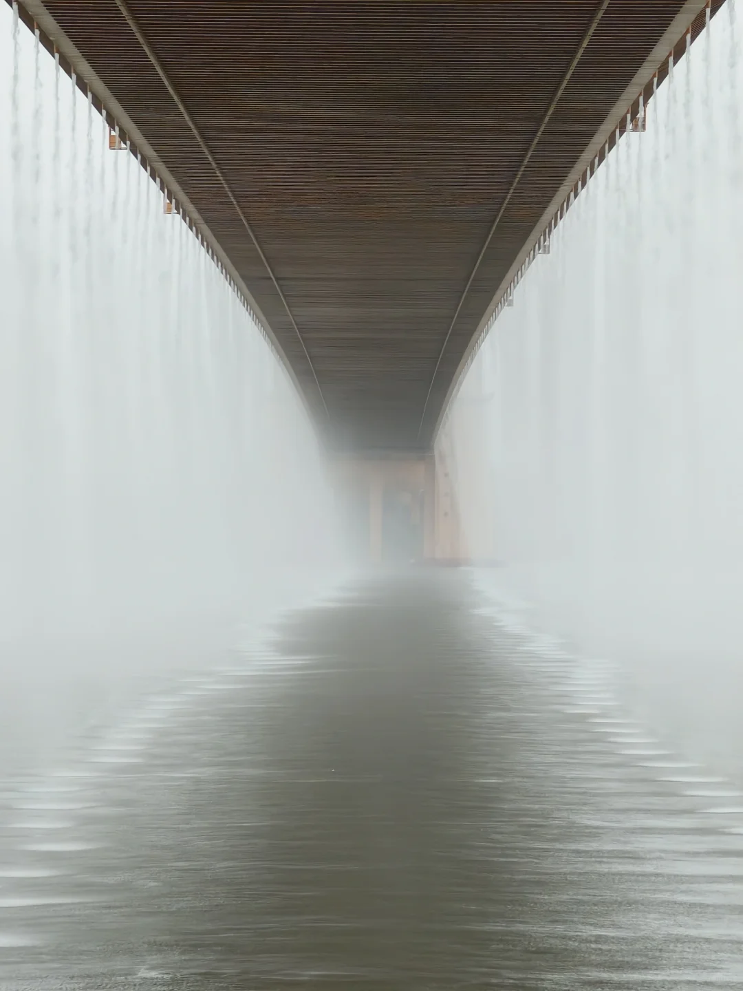 misty atmosphere around bridge base during rain